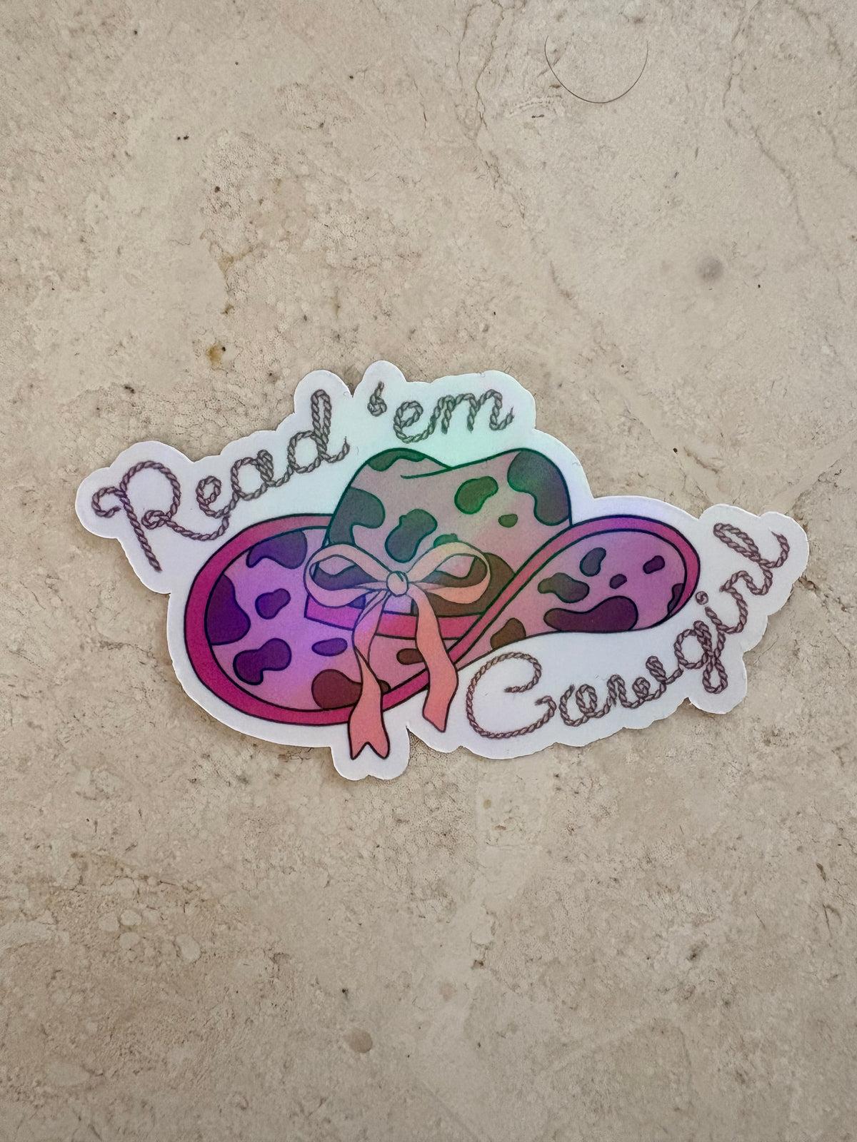 Read 'em Cowgirl bookish sticker featuring a colorful leopard print cowgirl hat.