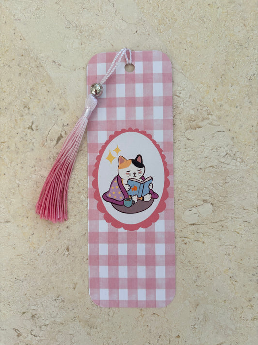 Pink gingham bookmark featuring a cute cat reading a book with a pink tassel.