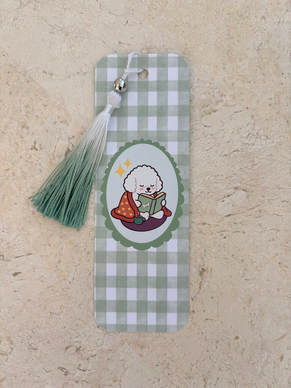 Green gingham bookmark with a cute poodle reading a book and a matching sage green tassel