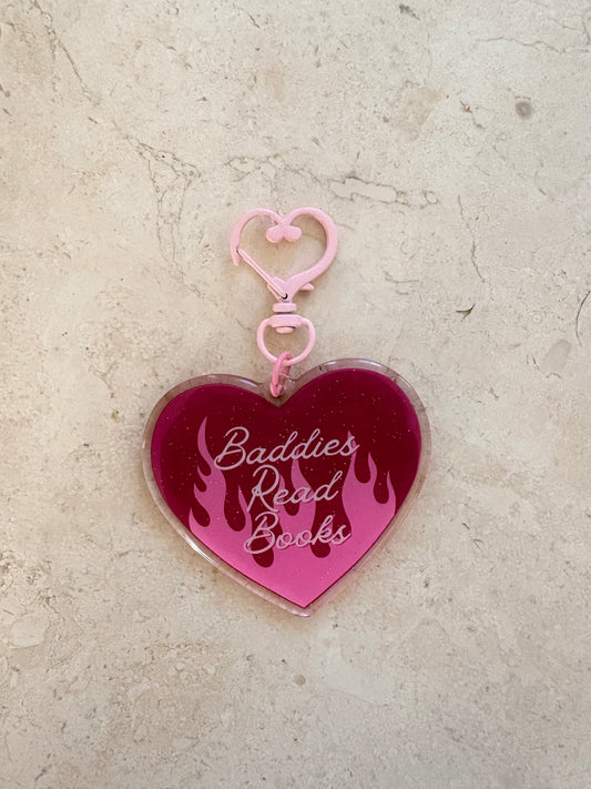 Heart-shaped pink acrylic bookish keychain with 'Baddies Read Books' and flame design