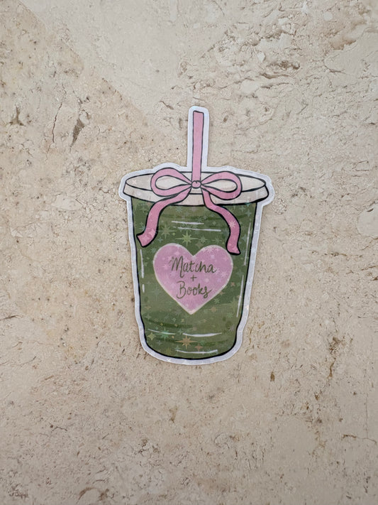 Matcha Books sticker featuring a green tea drink with a pink bow and heart.