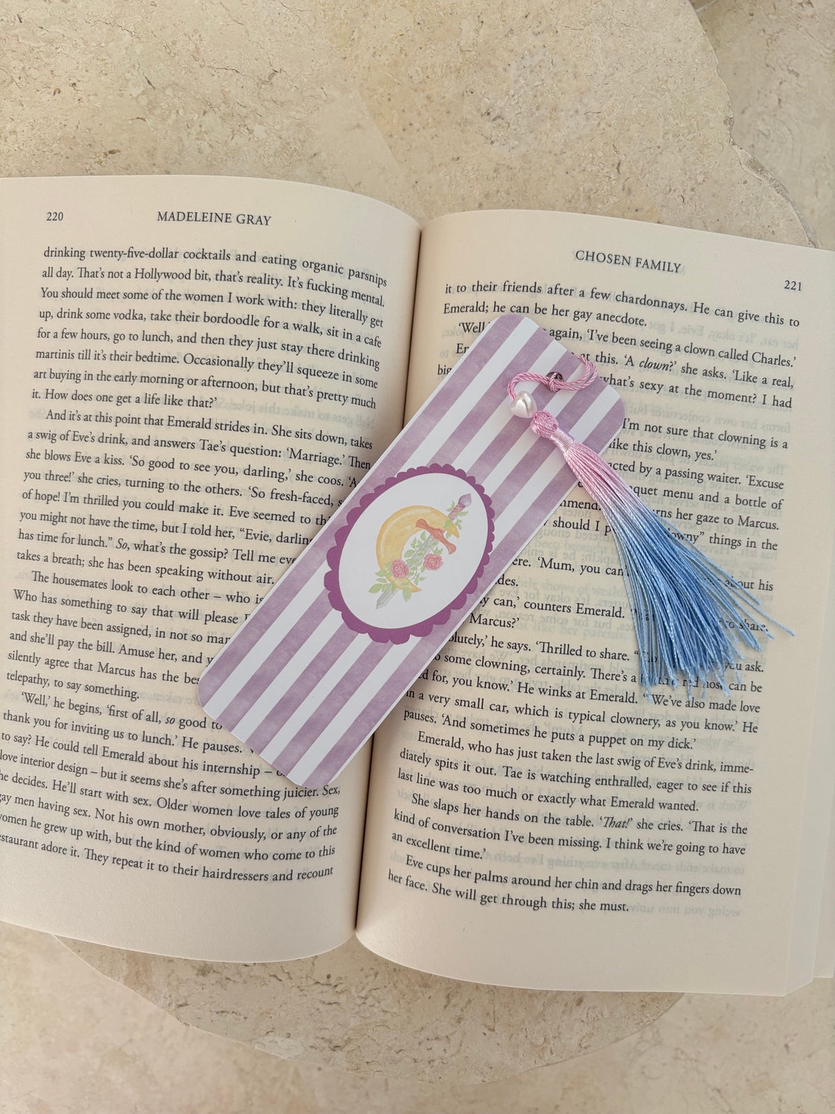 Sword bookmark. Two open pages from a novel titled 'Chosen Family' by Madeleine Gray.